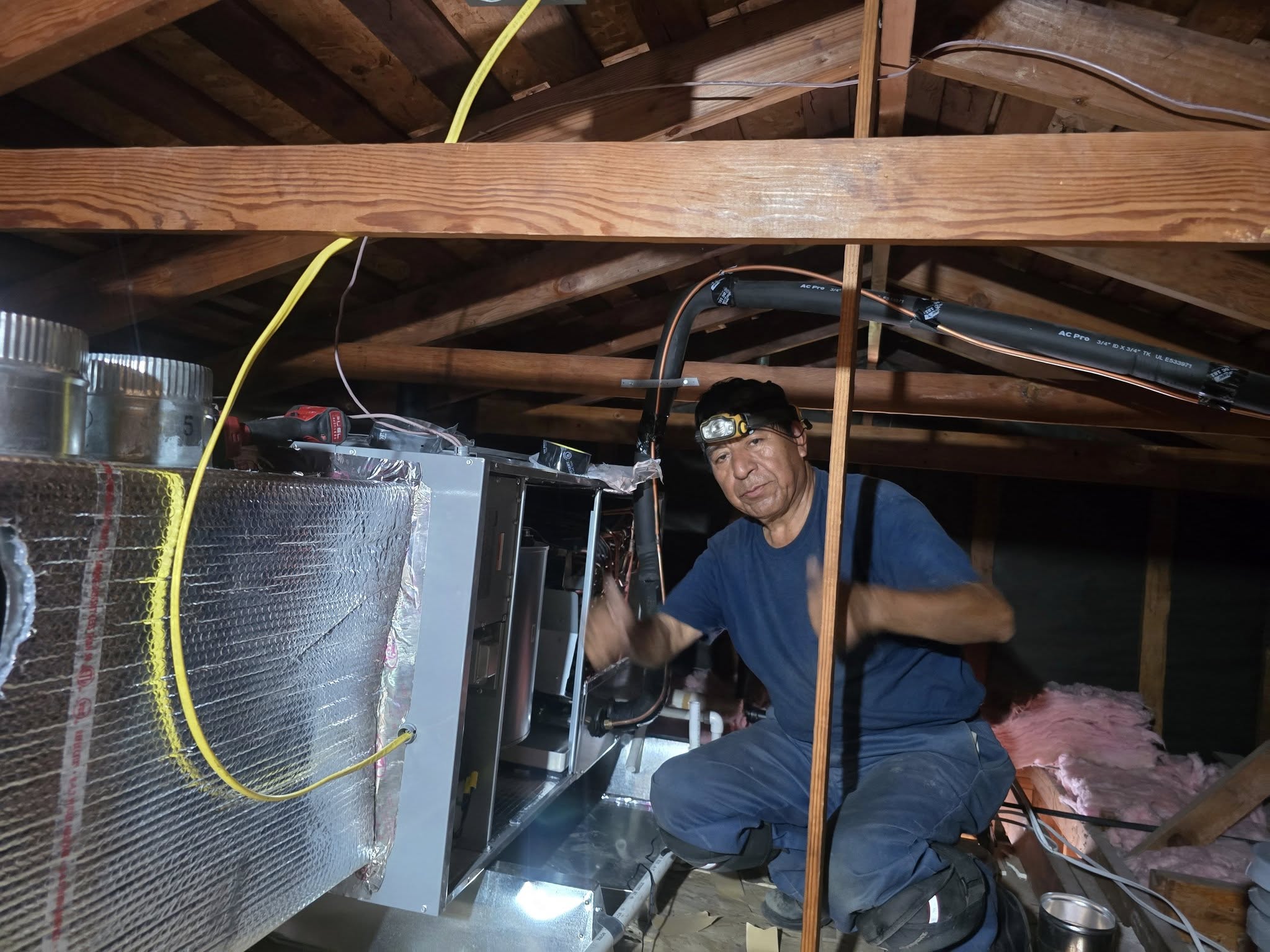 Technician working in attic
